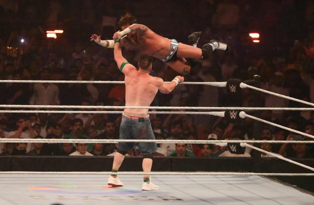 US wrestler John Cena (back) fights against CM Punk for the undisputed WWE Championship during the King of the Ring event at Kingdom Arena in Riyadh on June 28, 2025. (Photo by Fayez Nureldine / AFP)