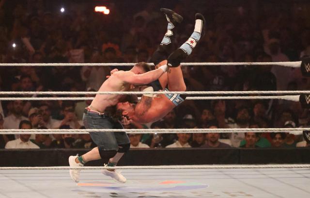 US wrestler John Cena (L) fights against CM Punk for the undisputed WWE Championship during the King of the Ring event at Kingdom Arena in Riyadh on June 28, 2025. (Photo by Fayez Nureldine / AFP)
