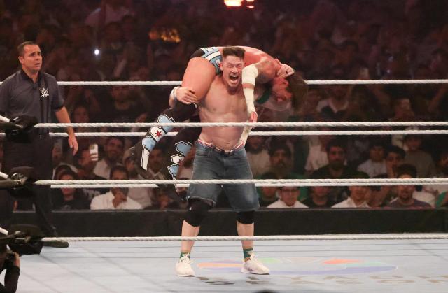 US wrestler John Cena (front) fights against CM Punk for the undisputed WWE Championship during the King of the Ring event at Kingdom Arena in Riyadh on June 28, 2025. (Photo by Fayez Nureldine / AFP)
