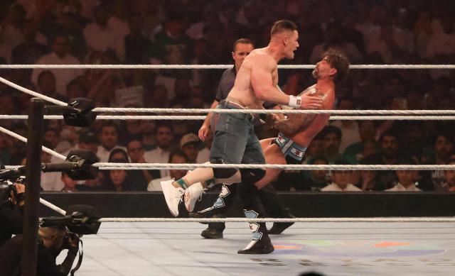 US wrestler John Cena (L) and US wrestler CM Punk fight during their match for the undisputed Championship King of the Ring at Kingdom Arena in Riyadh on June 28, 2025. (Photo by Fayez Nureldine / AFP)