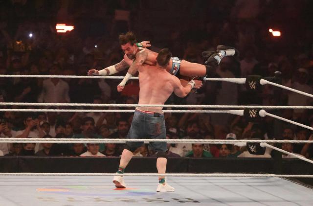 US wrestler John Cena (back) fights against CM Punk for the undisputed WWE Championship during the King of the Ring event at Kingdom Arena in Riyadh on June 28, 2025. (Photo by Fayez Nureldine / AFP)