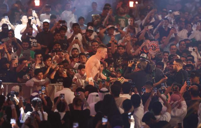 US wrestler John Cena celebrates after defeating US wrestler CM Punk fight during their match for the undisputed WWE Championship at Kingdom Arena in Riyadh on June 28, 2025. (Photo by Fayez Nureldine / AFP)