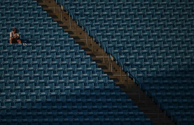 A fan is seen amid empty benches during the FIFA Club World Cup 2025 round of 16 football match between Portugal's Benfica and England's Chelsea at the Bank of America Stadium in Charlotte on June 28, 2025. (Photo by Paul ELLIS / AFP)