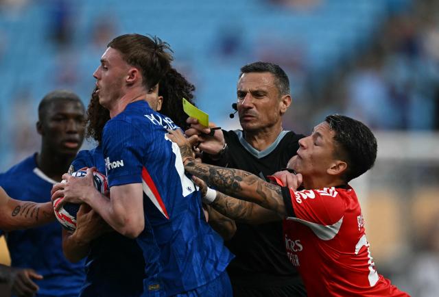 Slovenian referee Slavko Vincic gestures as Benfica's Argentine forward #25 Gianluca Prestianni and Chelsea's English midfielder #10 Cole Palmer shuffle during the FIFA Club World Cup 2025 round of 16 football match between Portugal's Benfica and England's Chelsea at the Bank of America Stadium in Charlotte on June 28, 2025. (Photo by Paul ELLIS / AFP)