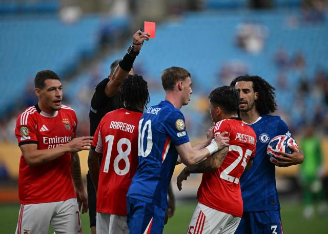 TOPSHOT - Slovenian referee Slavko Vincic shows a red card to Benfica's Argentine forward #25 Gianluca Prestianni during the FIFA Club World Cup 2025 round of 16 football match between Portugal's Benfica and England's Chelsea at the Bank of America Stadium in Charlotte on June 28, 2025. (Photo by Paul ELLIS / AFP)
