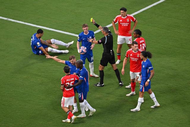 Slovenian referee Slavko Vincic shows a yellow card to Chelsea's English midfielder #10 Cole Palmer during the FIFA Club World Cup 2025 round of 16 football match between Portugal's Benfica and England's Chelsea at the Bank of America Stadium in Charlotte on June 28, 2025. (Photo by ANGELA WEISS / AFP)
