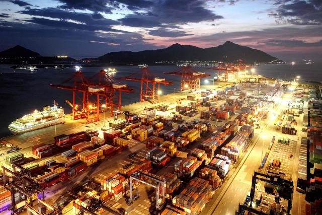This photo shows an aerial view of containers stacked at a port in Lianyungang, in eastern China's Jiangsu province on June 29, 2025. (Photo by AFP) / China OUT