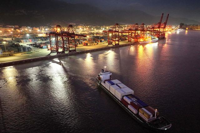 This photo shows an aerial view of a cargo ship loaded with containers leaving the port in Lianyungang, in eastern China's Jiangsu province on June 29, 2025. (Photo by AFP) / China OUT