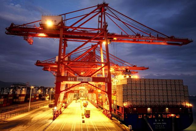 This photo shows a general view of a cargo ship loading containers at a port in Lianyungang, in eastern China's Jiangsu province on June 29, 2025. (Photo by AFP) / China OUT