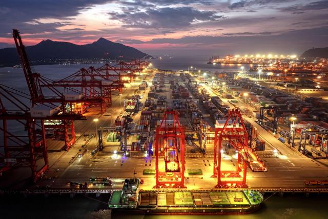 This photo shows an aerial view of containers stacked at a port in Lianyungang, in eastern China's Jiangsu province on June 29, 2025. (Photo by AFP) / China OUT