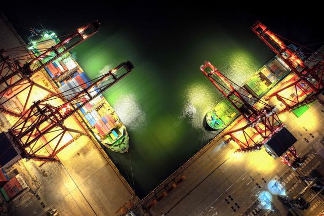 This photo shows an aerial view of cargo ships loading containers at a port in Lianyungang, in eastern China's Jiangsu province on June 29, 2025. (Photo by AFP) / China OUT