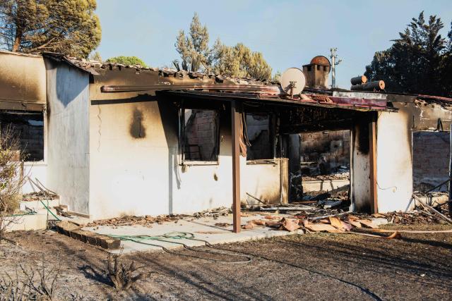A burned house stands among debris following a wildfire in the Seferihisar district of Izmir, Turkey, on June 30, 2025. Rescuers have evacuated more than 50,000 people, mostly from Turkey's western Izmir province, as firefighters battled a string of wildfires, the AFAD disaster agency said Monday. (Photo by Ahmet Ayberk Cimen / AFP)