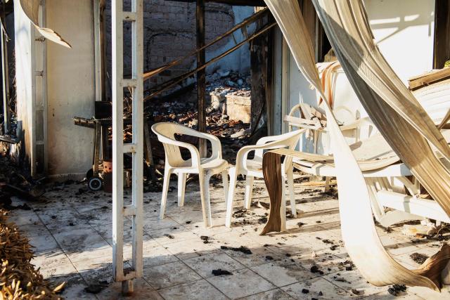 A burned house stands among debris following a wildfire in the Seferihisar district of Izmir, Turkey, on June 30, 2025. Rescuers have evacuated more than 50,000 people, mostly from Turkey's western Izmir province, as firefighters battled a string of wildfires, the AFAD disaster agency said Monday. (Photo by Ahmet Ayberk Cimen / AFP)