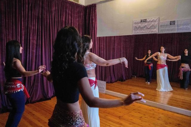 Egyptian belly-dancers Amie Sultan (R), Safaa Said (L), and Menna Emmam (C), full-time instructors at the Taksim Belly-dance Institute, take part in a rehearsal in Cairo on April 12, 2025. As belly dancing gains popularity internationally, young Egyptian performers are working to restore its reputation at home, pushing back against decades of stigma to reclaim the dance as part of their artistic heritage. Once iconic figures of Egypt's cinematic golden age, belly dancers have watched their prestige wane, their art increasingly confined to nightclubs and wedding halls. (Photo by Khaled DESOUKI / AFP)