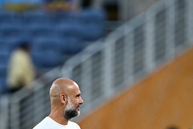 Manchester City's Spanish head coach Pep Guardiola looks on during the warmup ahead of the FIFA Club World Cup 2025 round of 16 football match between England's Manchester City and Saudi's Al-Hilal at the Camping World stadium in Orlando on June 30, 2025. (Photo by PATRICIA DE MELO MOREIRA / AFP)