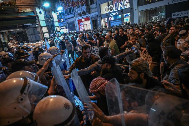 Islamist protesters clash with Turkish anti riot police officers as they gather to protests Leman cartoon magazine in Istanbul on June 30, 2025. Clashes erupted in Istanbul Monday with police firing rubber bullets and tear gas to break up an angry mob after allegations that a satirical magazine had published a cartoon of the Prophet Mohammed, an AFP correspondent said. The incident occurred after Istanbul's chief prosecutor ordered the arrest of the editors at LeMan magazine on grounds it had published a cartoon which "publicly insulted religious values". (Photo by Ozan KOSE / AFP)