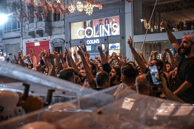Islamist protesters clash with Turkish anti riot police officers as they gather to protests Leman cartoon magazine in Istanbul on June 30, 2025. Clashes erupted in Istanbul Monday with police firing rubber bullets and tear gas to break up an angry mob after allegations that a satirical magazine had published a cartoon of the Prophet Mohammed, an AFP correspondent said. The incident occurred after Istanbul's chief prosecutor ordered the arrest of the editors at LeMan magazine on grounds it had published a cartoon which "publicly insulted religious values". (Photo by Ozan KOSE / AFP)