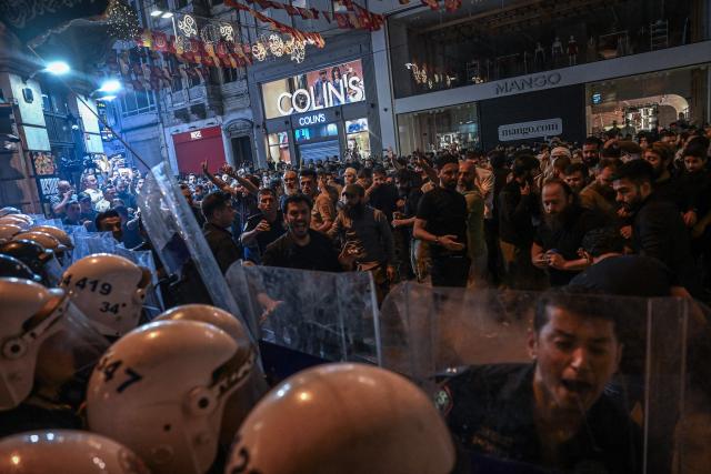 Islamist protesters clash with Turkish anti riot police officers as they gather to protests Leman cartoon magazine in Istanbul on June 30, 2025. Clashes erupted in Istanbul Monday with police firing rubber bullets and tear gas to break up an angry mob after allegations that a satirical magazine had published a cartoon of the Prophet Mohammed, an AFP correspondent said. The incident occurred after Istanbul's chief prosecutor ordered the arrest of the editors at LeMan magazine on grounds it had published a cartoon which "publicly insulted religious values". (Photo by Ozan KOSE / AFP)