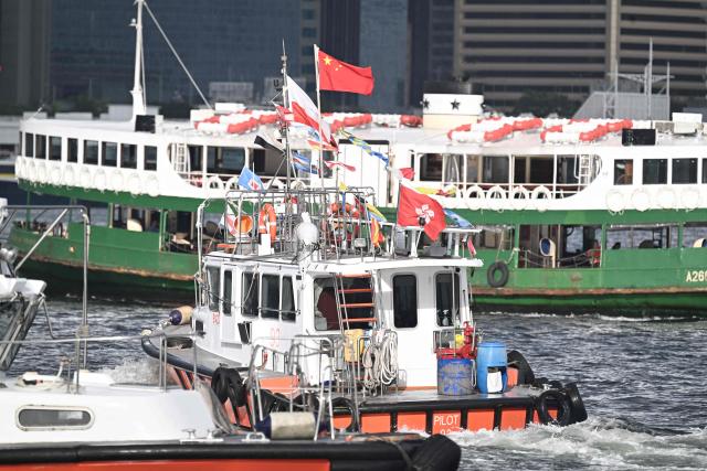 Boats are seen in Victoria Harbour during a flag-raising ceremony to mark the 28th anniversary of Hong Kong's handover from Britain to China in Hong Kong on July 1, 2025. (Photo by Peter PARKS / AFP)