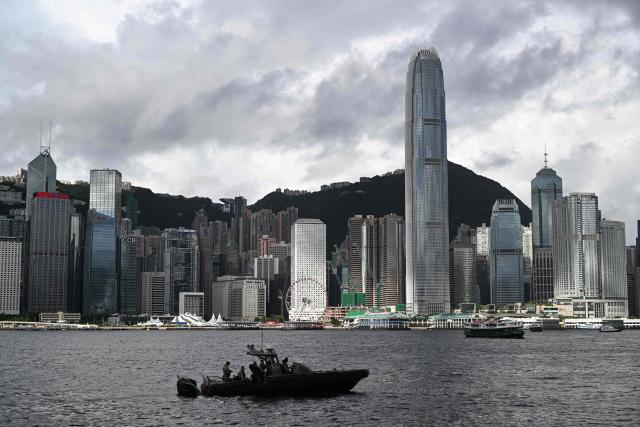 A police boat keeps watch in Victoria Harbour during a flag-raising ceremony to mark the 28th anniversary of Hong Kong's handover from Britain to China in Hong Kong on July 1, 2025. (Photo by Peter PARKS / AFP)