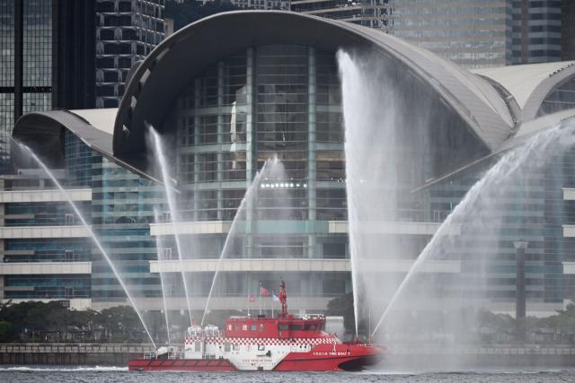 A fireboat sprays water in Victoria Harbour during a flag-raising ceremony to mark the 28th anniversary of Hong Kong's handover from Britain to China in Hong Kong on July 1, 2025. (Photo by Peter PARKS / AFP)