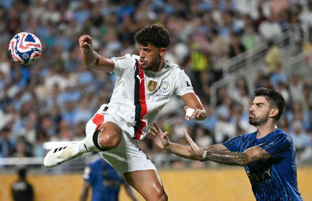 Manchester City's Portuguese midfielder #27 Matheus Nunes and Al Hilal's Portuguese midfielder #08 Ruben Neves fight for the ball during the FIFA Club World Cup 2025 round of 16 football match between England's Manchester City and Saudi's Al-Hilal at the Camping World stadium in Orlando on June 30, 2025. (Photo by Chandan Khanna / AFP)