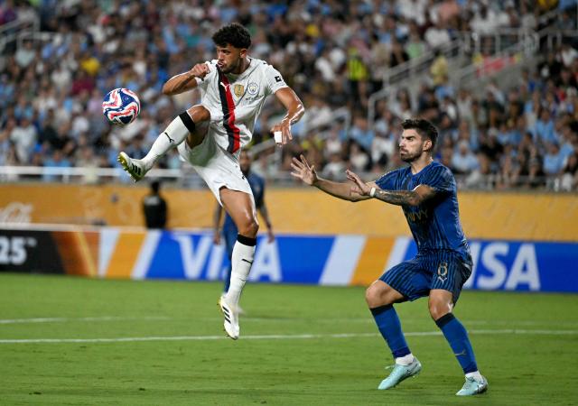 Manchester City's Portuguese midfielder #27 Matheus Nunes and Al Hilal's Portuguese midfielder #08 Ruben Neves fight for the ball during the FIFA Club World Cup 2025 round of 16 football match between England's Manchester City and Saudi's Al-Hilal at the Camping World stadium in Orlando on June 30, 2025. (Photo by Chandan Khanna / AFP)