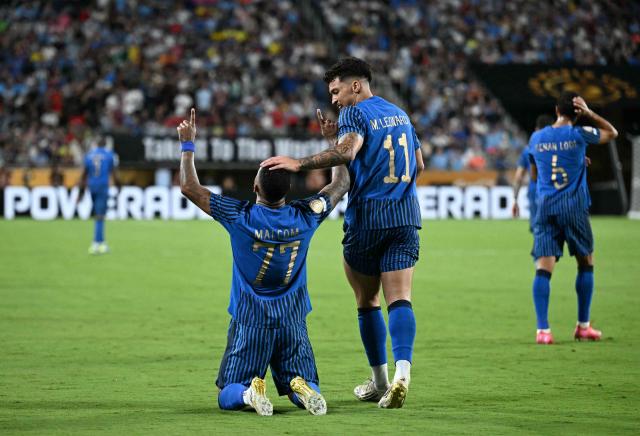 Al Hilal's Brazilian forward #77 Malcom celebrates after scoring his team's second goal with teammate Al Hilal's Brazilian forward #11 Marcos Leonardo during the FIFA Club World Cup 2025 round of 16 football match between England's Manchester City and Saudi's Al-Hilal at the Camping World stadium in Orlando on June 30, 2025. (Photo by Chandan Khanna / AFP)
