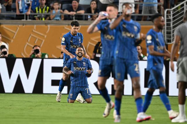 Al Hilal's Brazilian forward #77 Malcom (2nd-L) celebrates with teammate Brazilian forward #11 Marcos Leonardo after scoring his team's second goal during the FIFA Club World Cup 2025 round of 16 football match between England's Manchester City and Saudi's Al-Hilal at the Camping World stadium in Orlando on June 30, 2025. (Photo by PATRICIA DE MELO MOREIRA / AFP)