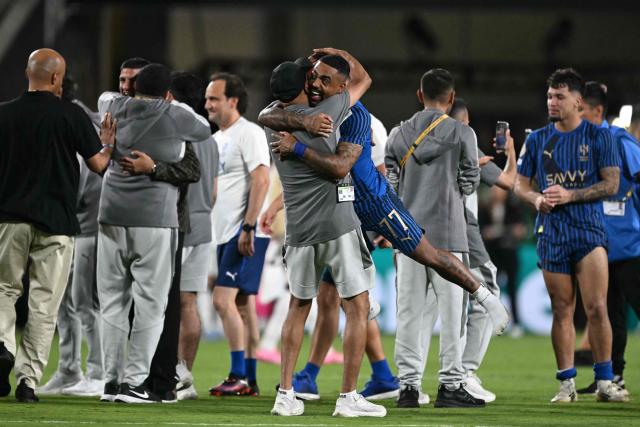 Al Hilal's Brazilian forward #77 Malcom celebrates with a staff member after winning the FIFA Club World Cup 2025 round of 16 football match between England's Manchester City and Saudi's Al-Hilal at the Camping World stadium in Orlando on June 30, 2025. (Photo by PATRICIA DE MELO MOREIRA / AFP)