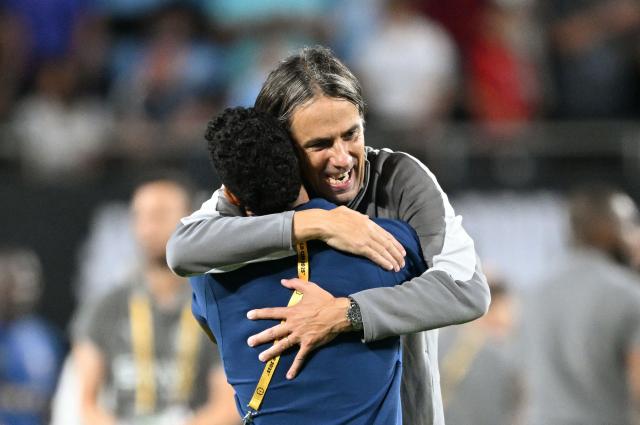 Al Hilal's Italian head coach Simone Inzaghi celebrates with a staff member after winning the FIFA Club World Cup 2025 round of 16 football match between England's Manchester City and Saudi's Al-Hilal at the Camping World stadium in Orlando on June 30, 2025. (Photo by CHANDAN KHANNA / AFP)