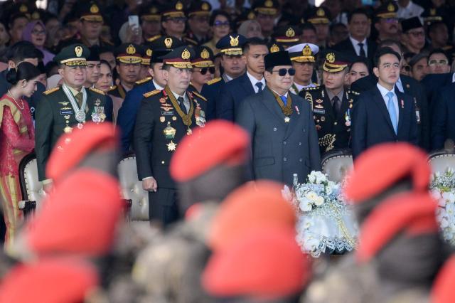 (L-R) Indonesian Armed Forces Commander General Agus Subiyanto, Indonesian National Police Chief General Listyo Sigit Prabowo, Indonesian President Prabowo Subianto, and Vice President Gibran Rakabuming Raka attend the 79th anniversary celebration of the Indonesian National Police held at the National Monument (known as Monas) in Jakarta on July 1, 2025. (Photo by BAY ISMOYO / AFP)