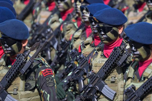 Indonesian police troops march during the 79th anniversary celebration of the Indonesian National Police held at the National Monument (known as Monas) in Jakarta on July 1, 2025. (Photo by BAY ISMOYO / AFP)