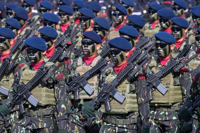 Indonesian police troops march during the 79th anniversary celebration of the Indonesian National Police held at the National Monument (known as Monas) in Jakarta on July 1, 2025. (Photo by BAY ISMOYO / AFP)
