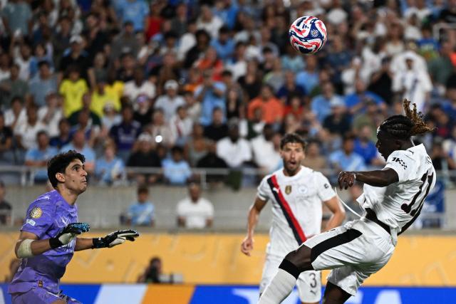 Manchester City's Belgian midfielder #11 Jeremy Doku heads the ball against Al Hilal's Moroccan goalkeeper #37 Yassine Bounou during the FIFA Club World Cup 2025 round of 16 football match between England's Manchester City and Saudi's Al-Hilal at the Camping World stadium in Orlando on June 30, 2025. (Photo by PATRICIA DE MELO MOREIRA / AFP)