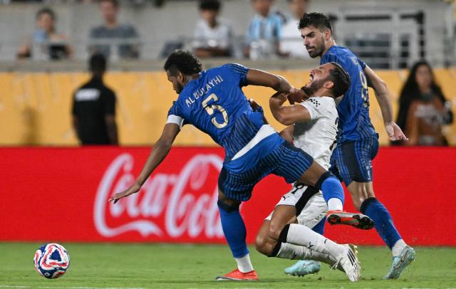 Manchester City's French midfielder #29 Rayan Cherki, Al Hilal's Saudi defender #05 Ali Al-Bulayhi and Portuguese midfielder #08 Ruben Neves fight for the ball during the FIFA Club World Cup 2025 round of 16 football match between England's Manchester City and Saudi's Al-Hilal at the Camping World stadium in Orlando on June 30, 2025. (Photo by CHANDAN KHANNA / AFP)