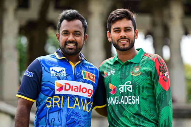 Sri Lanka's captain Charith Asalanka (L) poses with his Bangladesh counterpart Mehidy Hasan Miraz on the eve of their first one-day international (ODI) cricket match in Colombo on July 1, 2025. (Photo by Ishara S. KODIKARA / AFP)