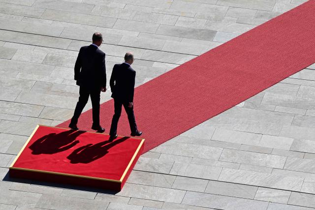 German Chancellor Friedrich Merz (L) and Luxembourg's Prime Minister Luc Frieden step off the podium before reviewing a military honor guard during an official welcome ceremony in front of the Chancellery in Berlin on July 1, 2025. (Photo by John MACDOUGALL / AFP)