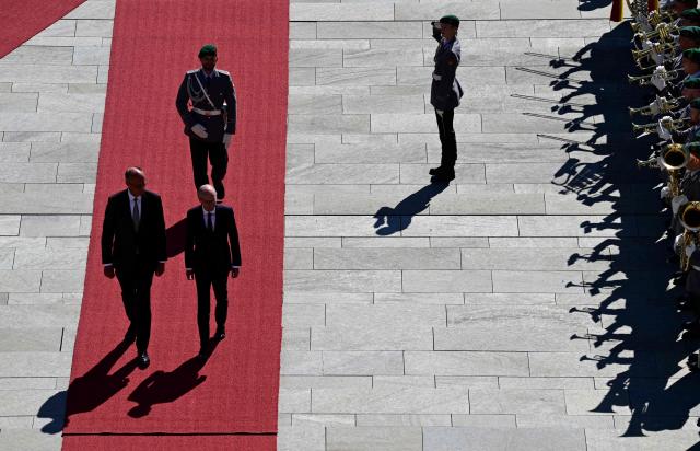 German Chancellor Friedrich Merz (L) and Luxembourg's Prime Minister Luc Frieden (2nd L) review a military honor guard during an official welcome ceremony in front of the Chancellery in Berlin on July 1, 2025. (Photo by John MACDOUGALL / AFP)