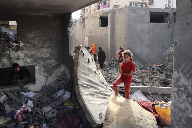 Palestinian children check the rubble of a residential house in Deir el-Balah in the central Gaza Strip on July 1, 2025, following overnight Israeli strikes as the war between the Palestinian Hamas militant and Israel continues. (Photo by Eyad BABA / AFP)