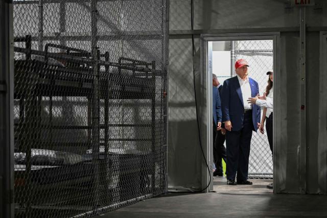 US President President Donald Trump tours a migrant detention center, dubbed "Alligator Alcatraz," located at the site of the Dade-Collier Training and Transition Airport in Ochopee, Florida on July 1, 2025. President Trump is visiting a migrant detention center in a reptile-infested Florida swamp dubbed "Alligator Alcatraz." Trump will attend the opening of the 5,000-bed facility -- located at an abandoned airfield in the Everglades wetlands -- part of his expansion of deportations of undocumented migrants, his spokeswoman said. (Photo by ANDREW CABALLERO-REYNOLDS / AFP)