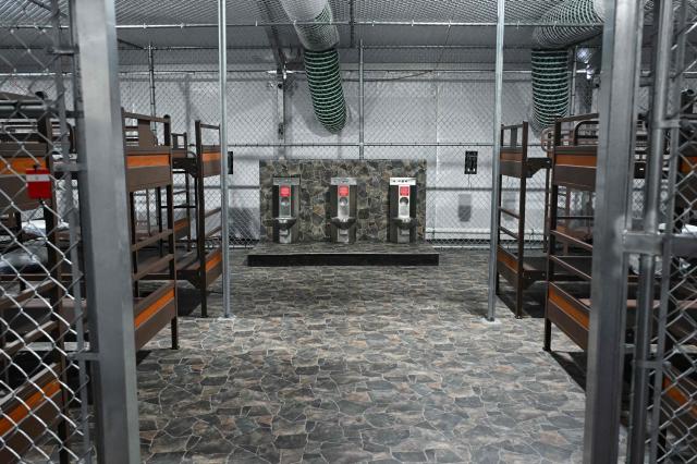 Toilets and beds are seen inside a migrant detention center, dubbed "Alligator Alcatraz," located at the site of the Dade-Collier Training and Transition Airport in Ochopee, Florida on July 1, 2025. US President Donald Trump is visiting a migrant detention center in a reptile-infested Florida swamp dubbed "Alligator Alcatraz." Trump will attend the opening of the 5,000-bed facility -- located at an abandoned airfield in the Everglades wetlands -- part of his expansion of deportations of undocumented migrants, his spokeswoman said. (Photo by ANDREW CABALLERO-REYNOLDS / AFP)