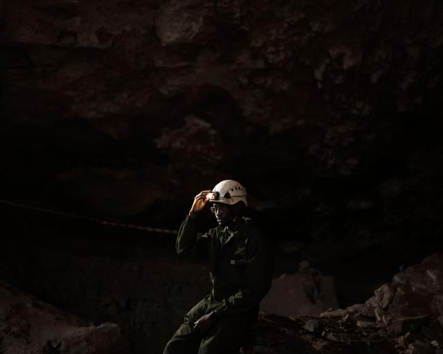 Tebogo Makhubela, a South African geologist recipient of one of the prestigious National Geographic 2025 Wayfinder Awards, dims the head lamp fixed on his safety helmet as he poses for a portrait inside the The Rising Star cave, in The Cradle of Humankind area, on June 26, 2025. Makhubela now leads a research team working to uncover ancient clues of human evolution.
His turf lies below the surface of the Earth, in the limestone caves of South Africa's Cradle of Humankind, a UNESCO World Heritage Site about 50 kilometres (30 miles) northwest of Johannesburg. (Photo by MARCO LONGARI / AFP)