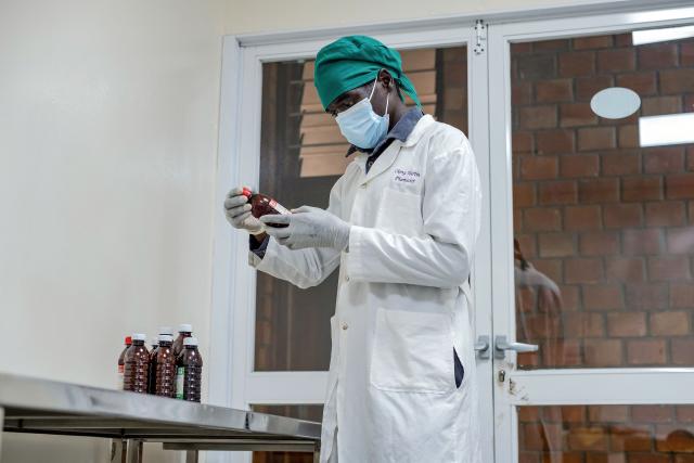 A chemist inspects bottles of liquid morphine at the Morphine Production Unit of Hospice Africa Uganda (HAU) in Kampala, on June 26, 2025. Hospice Africa Uganda (HAU), founded in 1993 by Dr Anne Merriman, brought holistic end-of-life care to Uganda at a time when it was offered in only three African countries.
By the time Merriman died in May 2025, aged 90, she had treated more than 40,000 patients in Uganda and her model had spread to 37 African countries. (Photo by Badru Katumba / AFP)