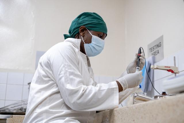 A chemist prepares liquid morphine at the Morphine Production Unit of Hospice Africa Uganda (HAU) in Kampala, on June 26, 2025. Hospice Africa Uganda (HAU), founded in 1993 by Dr Anne Merriman, brought holistic end-of-life care to Uganda at a time when it was offered in only three African countries.
By the time Merriman died in May 2025, aged 90, she had treated more than 40,000 patients in Uganda and her model had spread to 37 African countries. (Photo by Badru Katumba / AFP)