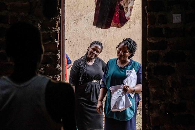 Jane Mwesige (R), a nurse at Hospice Africa Uganda (HAU), stands at the door of patient Jonathan Luzige's home while carrying morphine and other medicines for a home visit in Nabbingo, on June 26, 2025. Hospice Africa Uganda (HAU), founded in 1993 by Dr Anne Merriman, brought holistic end-of-life care to Uganda at a time when it was offered in only three African countries.
By the time Merriman died in May 2025, aged 90, she had treated more than 40,000 patients in Uganda and her model had spread to 37 African countries. (Photo by Badru Katumba / AFP)