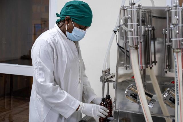 A chemist prepares liquid morphine at the Morphine Production Unit of Hospice Africa Uganda (HAU) in Kampala, on June 26, 2025. Hospice Africa Uganda (HAU), founded in 1993 by Dr Anne Merriman, brought holistic end-of-life care to Uganda at a time when it was offered in only three African countries.
By the time Merriman died in May 2025, aged 90, she had treated more than 40,000 patients in Uganda and her model had spread to 37 African countries. (Photo by Badru Katumba / AFP)