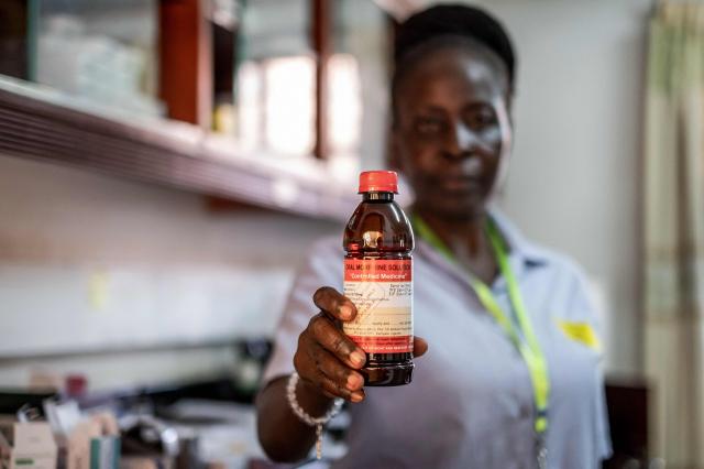 Medical dispenser Sarah Nakyanzi shows a bottle of morphine produced and distributed by Hospice Africa Uganda (HAU) inside the office drug store in Kampala, June 24, 2025. Hospice Africa Uganda (HAU), founded in 1993 by Dr Anne Merriman, brought holistic end-of-life care to Uganda at a time when it was offered in only three African countries.
By the time Merriman died in May 2025, aged 90, she had treated more than 40,000 patients in Uganda and her model had spread to 37 African countries. (Photo by Badru Katumba / AFP)