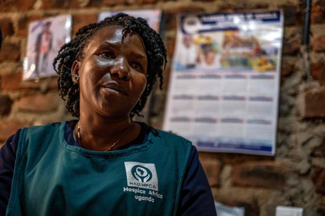 Jane Mwesige, a nurse at Hospice Africa Uganda (HAU), listens to patient Jonathan Luzige and his sister during a home visit in Nabbingo, on June 26, 2025. Hospice Africa Uganda (HAU), founded in 1993 by Dr Anne Merriman, brought holistic end-of-life care to Uganda at a time when it was offered in only three African countries.
By the time Merriman died in May 2025, aged 90, she had treated more than 40,000 patients in Uganda and her model had spread to 37 African countries. (Photo by Badru Katumba / AFP)