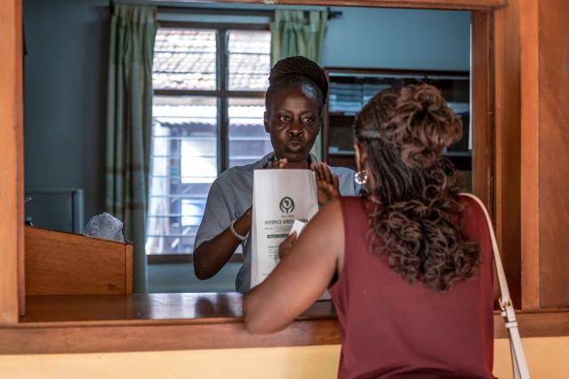 Medical dispenser Sarah Nakyanzi (C) delivers some morphine produced and distributed by Hospice Africa Uganda (HAU) at the office drug store in Kampala, June 24, 2025. Hospice Africa Uganda (HAU), founded in 1993 by Dr Anne Merriman, brought holistic end-of-life care to Uganda at a time when it was offered in only three African countries.
By the time Merriman died in May 2025, aged 90, she had treated more than 40,000 patients in Uganda and her model had spread to 37 African countries. (Photo by Badru Katumba / AFP)